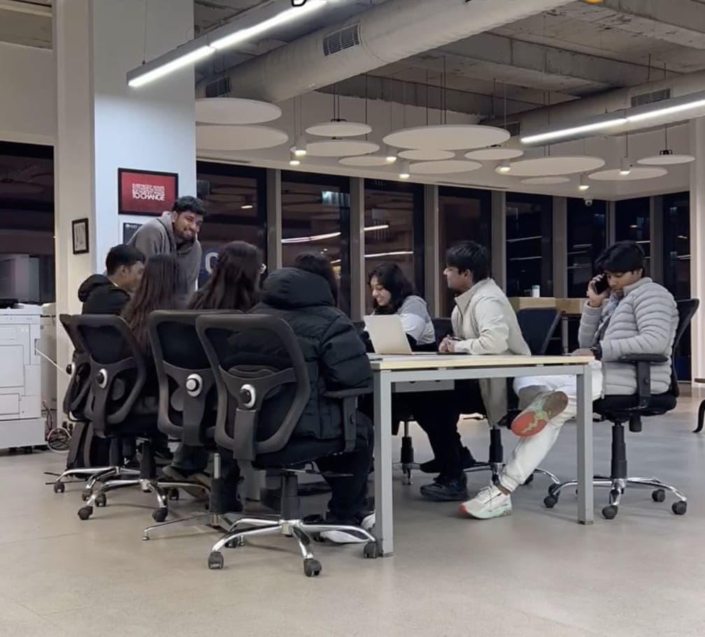 The NexCRAFT team gathered around a table in a working meeting